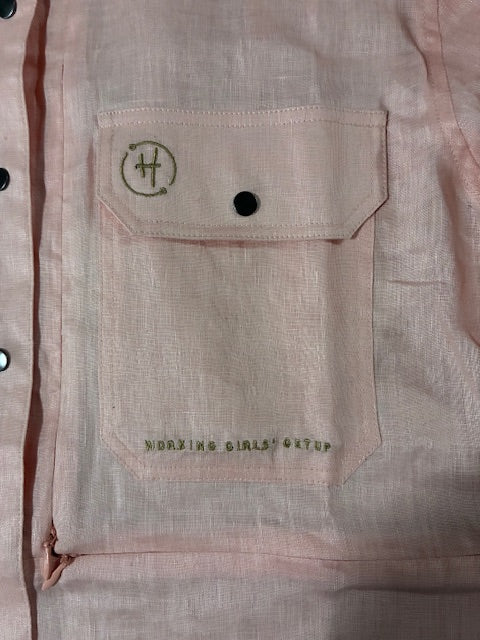 Close-up of a beige fabric with a logo and text on a garment